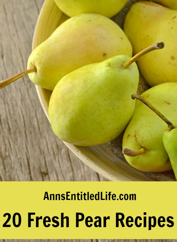 A wooden bowl filled with green pears