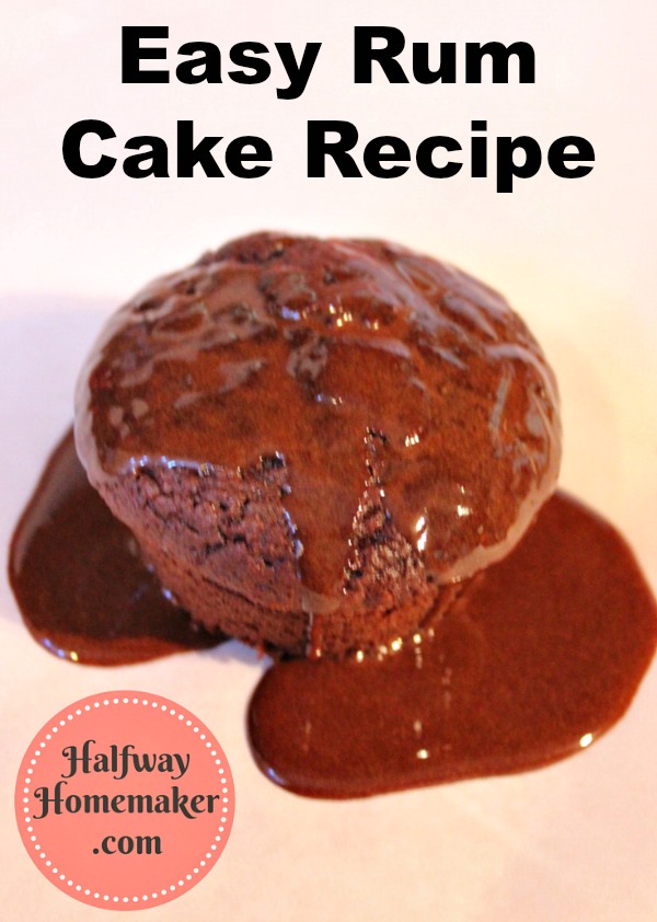 a rum baked cupcake covered in chocolate sauce on a plain counter