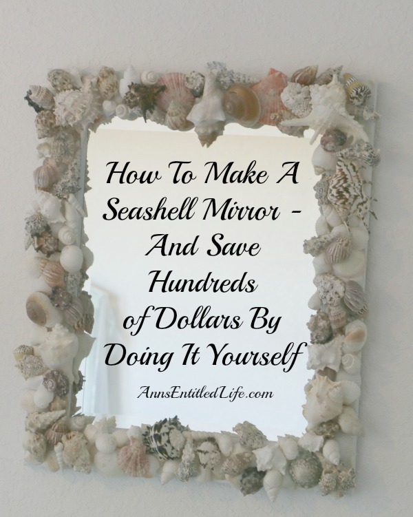 Handmade vertical seashell mirror hanging on a wall