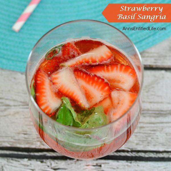 Strawberry Basil Sangria. A fun and delicious strawberry sangria recipe! Great for a sweet dinner drink, party libation or anytime cocktail, this Strawberry Basil Sangria is a perfect weekend beverage for adults.