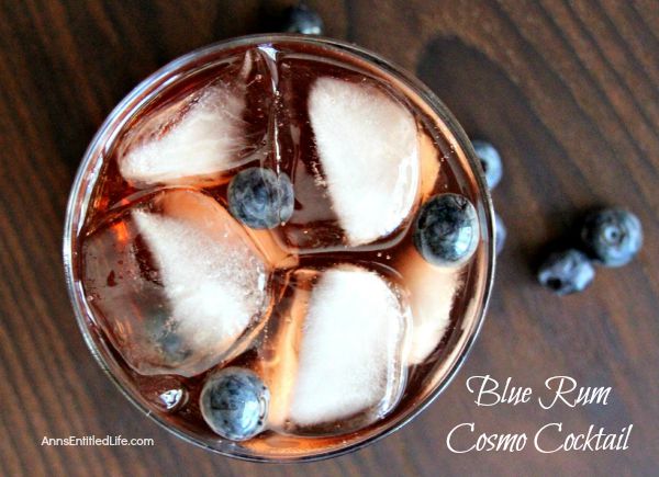 Blue Rum Cosmo Cocktail; a rum take on the traditional cosmopolitan recipe. This easy to prepare blue rum cosmo cocktail will delight your taste buds year round.