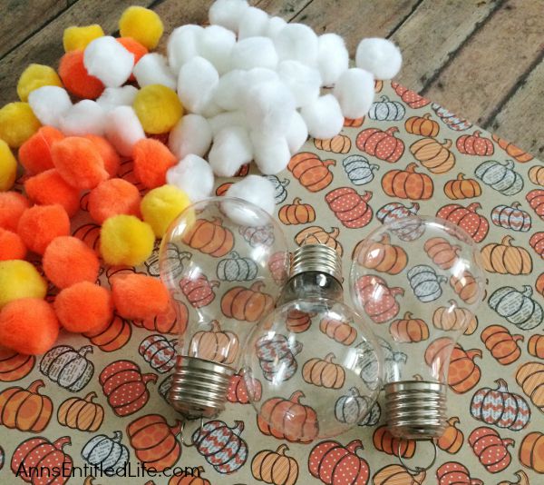 Candy Corn Light Bulb Craft; this super cute candy corn light bulb craft that is easy enough for a child to make (with adult supervision). These candy corn light bulbs can be strung on a ribbon as a banner, hung in a window as décor, or set up in on your table on a dish or nestled in popcorn as a centerpiece!