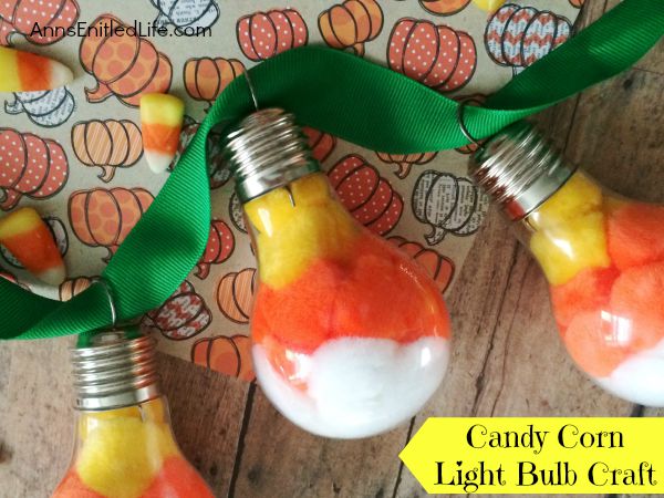 Candy Corn Light Bulb Craft; this super cute candy corn light bulb craft that is easy enough for a child to make (with adult supervision). These candy corn light bulbs can be strung on a ribbon as a banner, hung in a window as décor, or set up in on your table on a dish or nestled in popcorn as a centerpiece!