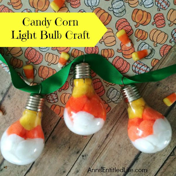 Candy Corn Light Bulb Craft; this super cute candy corn light bulb craft that is easy enough for a child to make (with adult supervision). These candy corn light bulbs can be strung on a ribbon as a banner, hung in a window as décor, or set up in on your table on a dish or nestled in popcorn as a centerpiece!