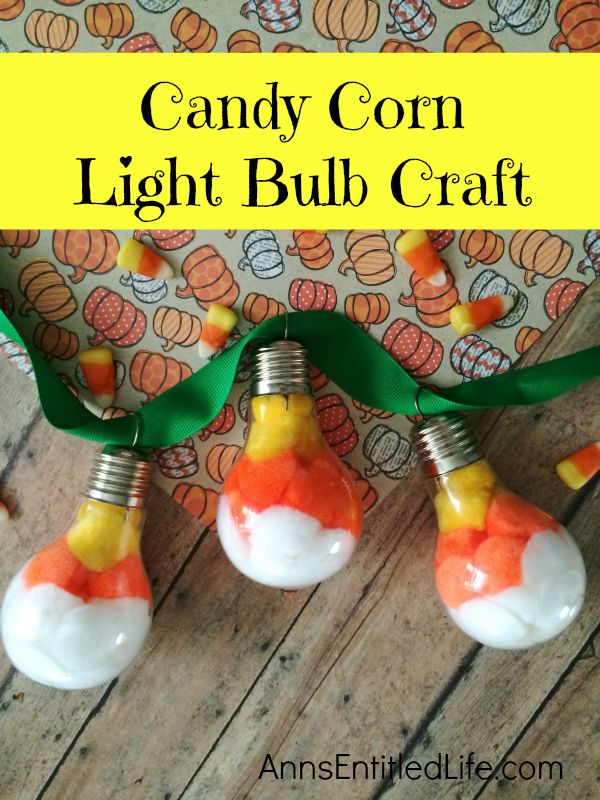 Candy Corn Light Bulb Craft; this super cute candy corn light bulb craft that is easy enough for a child to make (with adult supervision). These candy corn light bulbs can be strung on a ribbon as a banner, hung in a window as décor, or set up in on your table on a dish or nestled in popcorn as a centerpiece!