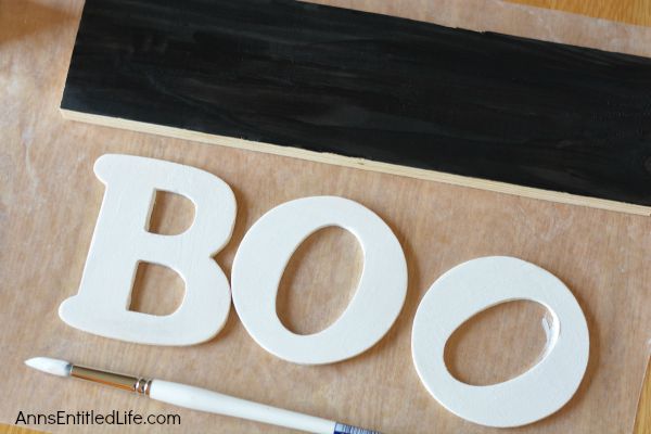 DIY Boo Pallet Project; An easy to make Halloween decoration. Easily, quickly, and inexpensively make this cute Boo Pallet to add to your Halloween mantel display, hang on a door, or prop on a frame on a table.  These simple step by step instructions make this DIY Boo Pallet Project effortless.