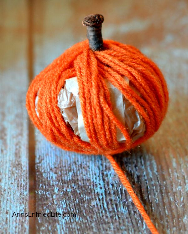 Easy DIY No-Sew Yarn Pumpkins; these No-Sew Yarn Wrapped Pumpkins are super easy to make, require no special crafting skills and are totally adorable. If you need a quick fall craft, or would like a (supervised) project for your children on a rainy weekend, these pumpkins are a terrific craft project.