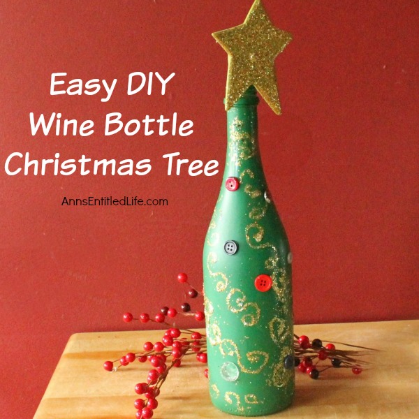 Easy DIY Wine Bottle Christmas Tree. An empty wine bottle, some glitter, paint and glue combined with a little imagination easily transforms into a pretty holiday decoration! Upcycle your empty wine bottles to make a lovely Christmas Tree decoration. Make one or make a grouping to form a centerpiece, mantel decoration, or unique side table decor.