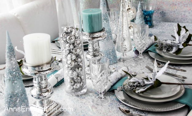 Winter Holiday Tablescape: White, Silver and Blue. Hosting a holiday party? Dressing up the table for Christmas, New Year's or just because? Break away from the traditional green and red Christmas colors and try something entirely different. This beautiful winter holiday tablescape features white, silver and blue. A lovely cool theme to compliment the winter landscape. 