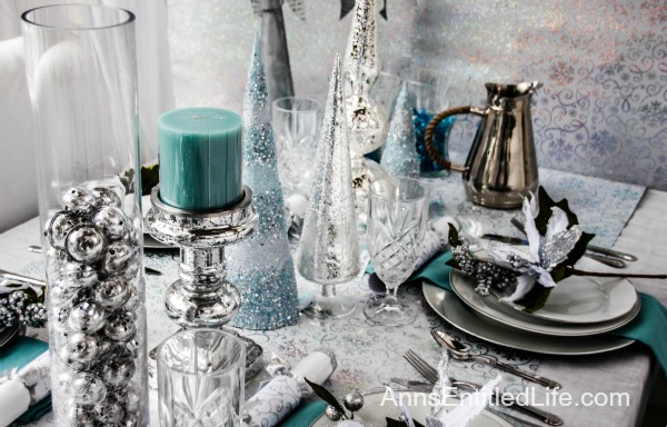 Winter Holiday Tablescape: White, Silver and Blue. Hosting a holiday party? Dressing up the table for Christmas, New Year's or just because? Break away from the traditional green and red Christmas colors and try something entirely different. This beautiful winter holiday tablescape features white, silver and blue. A lovely cool theme to compliment the winter landscape. 