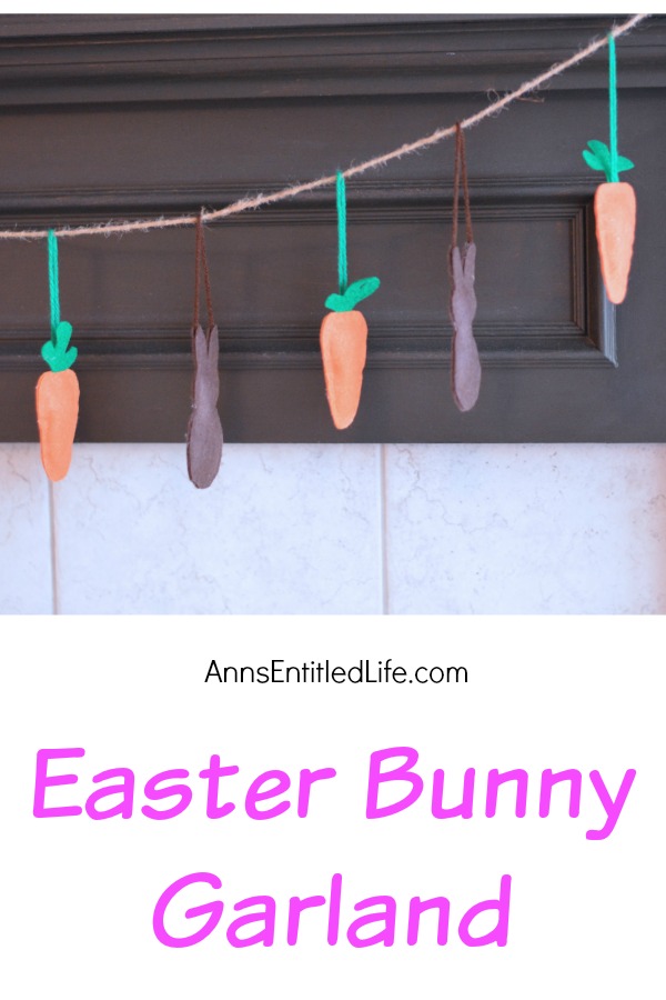 a garland made of stuffed bunnies and carrots hanging by a fireplace