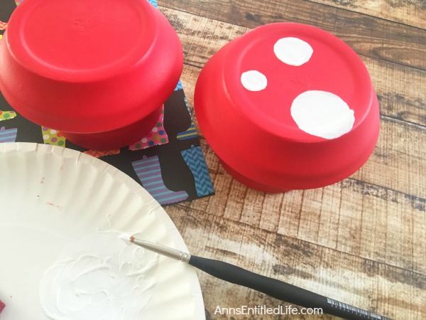 DIY Terra Cotta Garden Mushrooms. Make your own cute garden decor simply and inexpensively! Here's an easy step by step tutorial on how to make these DIY Terra Cotta Garden Mushrooms to brighten up and add a touch of whimsy your gardens.