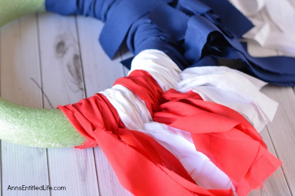 Easy DIY Flag Wreath. Make your own no-sew Flag Wreath using these easy step by step instructions. This cute patriotic decor is perfect for Memorial Day, Independence Day, or any day! Simple and inexpensive to make, this Easy DIY Flag Wreath will add a marvelous touch of whimsy to your holiday decor.