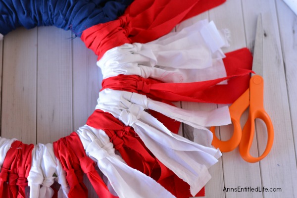 Easy DIY Flag Wreath. Make your own no-sew Flag Wreath using these easy step by step instructions. This cute patriotic decor is perfect for Memorial Day, Independence Day, or any day! Simple and inexpensive to make, this Easy DIY Flag Wreath will add a marvelous touch of whimsy to your holiday decor.