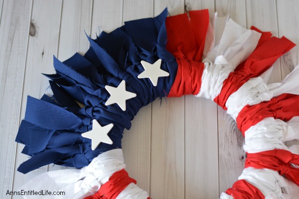 Easy DIY Flag Wreath. Make your own no-sew Flag Wreath using these easy step by step instructions. This cute patriotic decor is perfect for Memorial Day, Independence Day, or any day! Simple and inexpensive to make, this Easy DIY Flag Wreath will add a marvelous touch of whimsy to your holiday decor.
