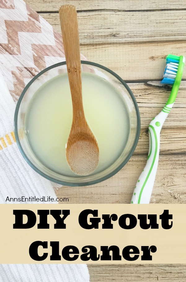 homemade grout cleaner in glass bowl next to a toothbrush on a wooden board