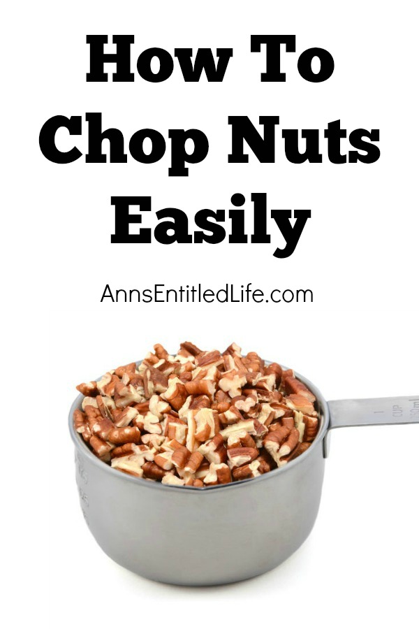 chopped nuts in measuring cup on white background