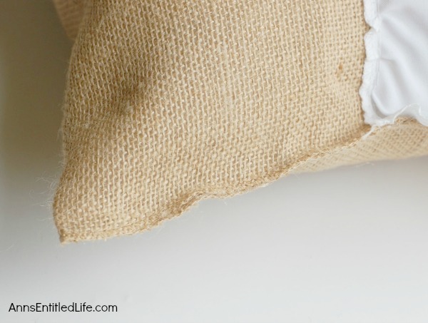 DIY Easy No Sew Throw Pillow. Make this easy, no sew throw pillow for a quick decor update. This step by step tutorial will teach you how to make this no sew ruffle burlap pillow in a short time. Simple to make, this ruffled burlap pillow is adorable for bed decor, family room decor or even casual living room decor!