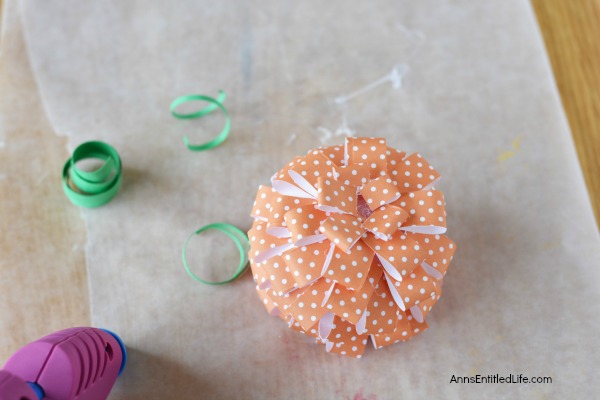 Paper Pumpkin Craft. This sweet little Paper Pumpkin Craft is perfect for autumn decor! Make one, make three, make a dozen; the more the merrier and they are easy to fabricate. Whether looking for mantel or tablescape decorations or just a whimsical adornment for a side table or windowsill, this simple to make Paper Pumpkin Craft is a great addition to your fall decorating scheme.