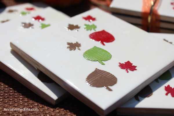 Easy DIY Autumn Coasters. These DIY Autumn coasters are simple to make. Instead of resin, they use a spray to form a heat resistant coating (to 500 degrees!) which seals and protects. Add a touch of fall decor to your living area with these easy to make autumn coasters.