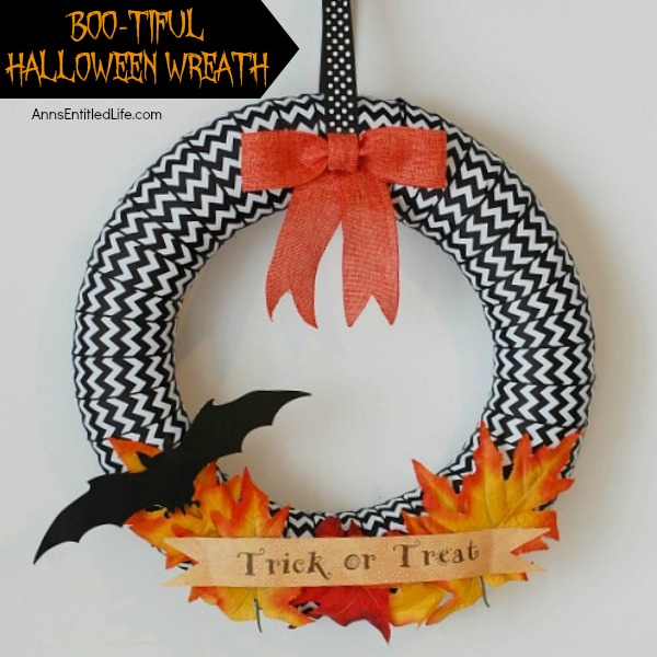 BOO-Tiful Halloween Wreath. While this beautiful DIY Halloween Wreath will not scare anyone, it is lovely and stylish Halloween decor. Hang this Halloween wreath on your front door, side door, over a mantel - anywhere you place seasonal wreath decor. These easy to follow step by step instruction tutorial will have you completing this BOO-Tiful Halloween Wreath in no time flat!