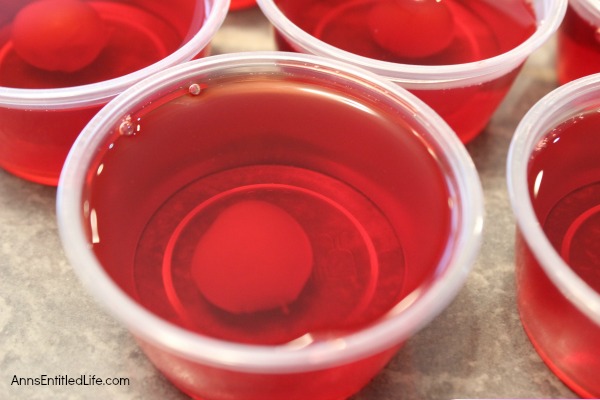 Cherry Surprise Jello Shots Recipe. This delightful cherry almond jello shot offers a nice little surprise in the middle. Simple to make, these Cherry Surprise Jello Shots are great for parties, tailgating, and more!