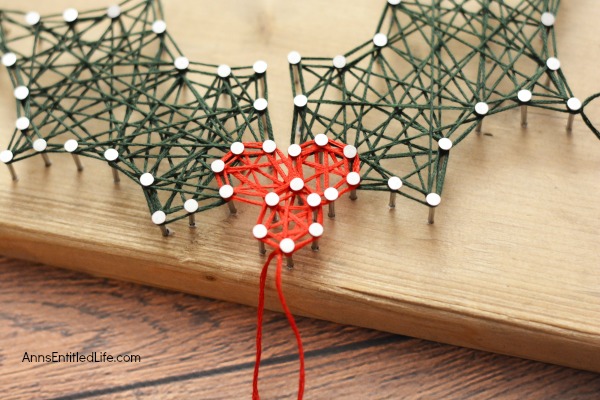 Holly Berry String Art. Make your own beautiful Holly Berry String Art with this step by step tutorial. Included are the printable patterns, easy to follow directions and tutorial photographs so you can make this lovely Christmas craft yourself. Keep for yourself, or give as a gift!
