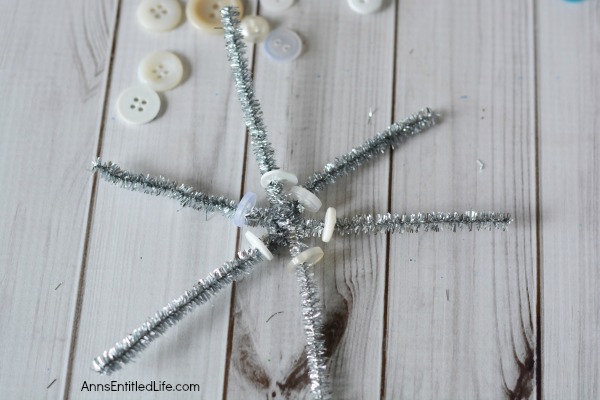 Easy DIY Button Snowflake Ornament. An Easy DIY Button Snowflake Ornament craft anyone can make. This is a simple Christmas tree ornament to add to your handmade collection. 