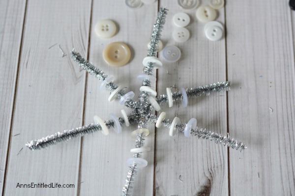 Easy DIY Button Snowflake Ornament. An Easy DIY Button Snowflake Ornament craft anyone can make. This is a simple Christmas tree ornament to add to your handmade collection. 