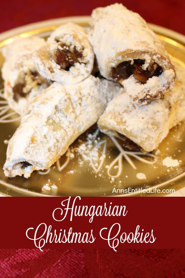 A cgold plate filled with Hungarian Christmas cookies covered in powdered sugar