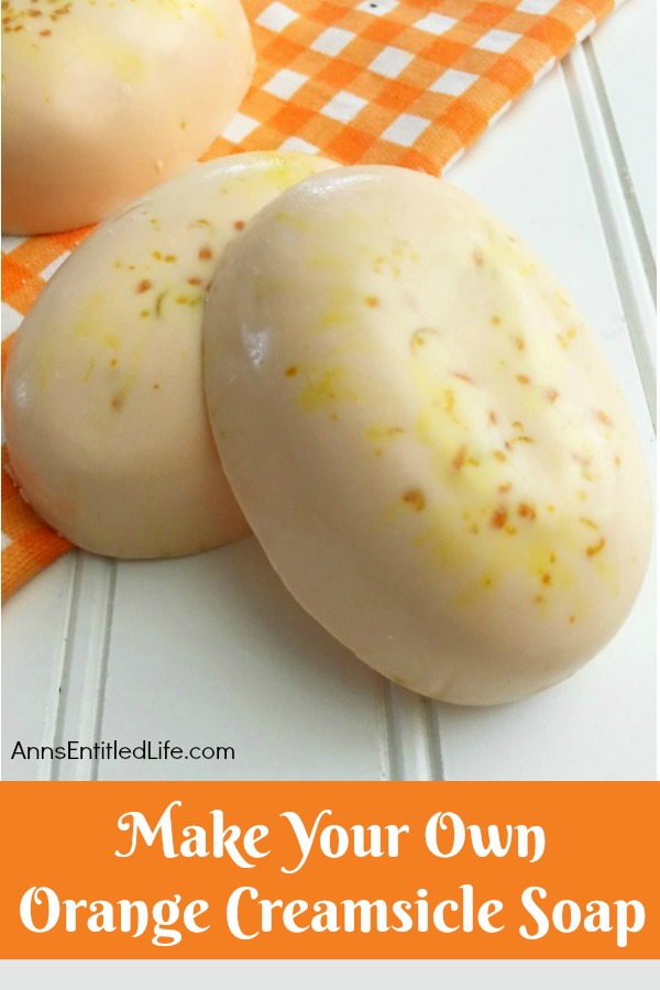 orange soap and orange kitchen towel on beadboard background