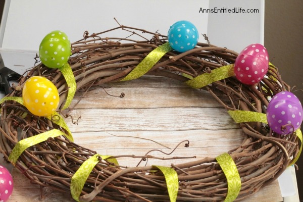 DIY Easter Egg Wreath. This Easter egg grapevine wreath is a wonderful spring door craft. This cute, simple to make, Easter egg wreath is an inexpensive Easter decoration, perfect decor for your door, over your fireplace or on a wall.