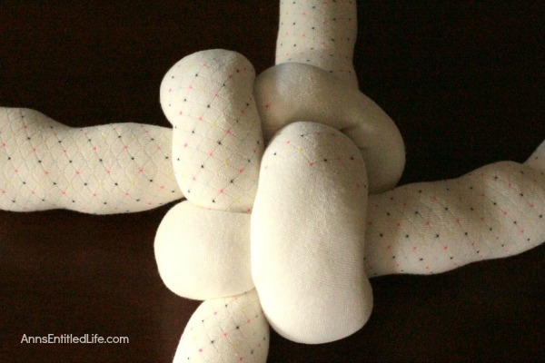 How to Make a Knot Pillow DIY Tutorial. You will not believe how simple it is to make this trendy pillow knot design. This knot pillow DIY version costs a whole lot less than a store bought pillow knot, and only takes about an hour to make.