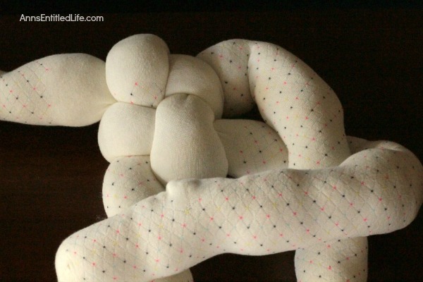 How to Make a Knot Pillow DIY Tutorial. You will not believe how simple it is to make this trendy pillow knot design. This knot pillow DIY version costs a whole lot less than a store bought pillow knot, and only takes about an hour to make.