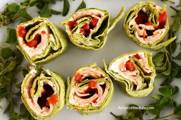 Turkey Cream Cheese Pinwheels Recipe. Whether served as an appetizer or as a lunch entree, these tasty pinwheels really hit the spot. A colorful and unique update to the classic pinwheel recipe, these turkey cream cheese pinwheels are bursting with flavor. The next time you are looking for an easy to make finger food give these creamy delights a try!