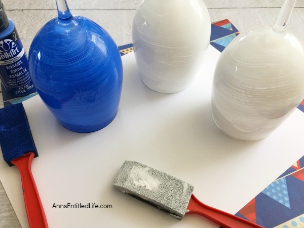 Flag Wineglass DIY. Make your own unique patriotic flag wineglasses! This easy step by step tutorial will show you how to easily make flag wineglass decor which are perfect for a centerpiece, mantel decor or table decorations. This is an easy to make craft project.