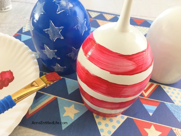 Flag Wineglass DIY. Make your own unique patriotic flag wineglasses! This easy step by step tutorial will show you how to easily make flag wineglass decor which are perfect for a centerpiece, mantel decor or table decorations. This is an easy to make craft project.