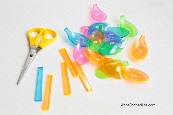 DIY Floating Spoon Flowers. Make your own floating flowers from plastic spoons! These simple to make floating flowers would be perfect to use at a wedding, summer party, in a backyard pool, or to light up in your backyard pond.