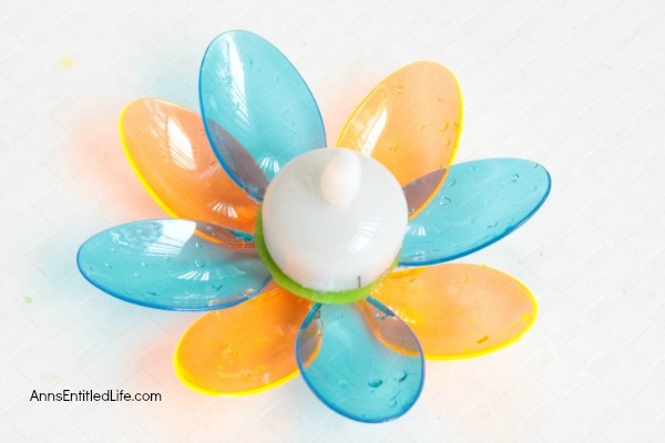 DIY Floating Spoon Flowers. Make your own floating flowers from plastic spoons! These simple to make floating flowers would be perfect to use at a wedding, summer party, in a backyard pool, or to light up in your backyard pond.
