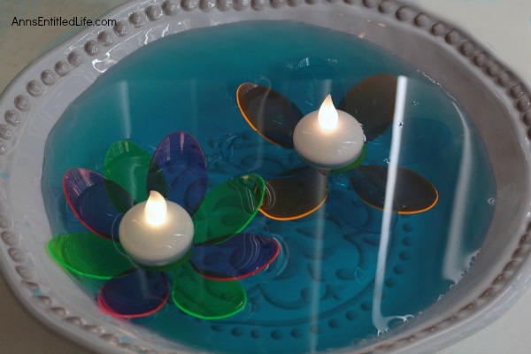 DIY Floating Spoon Flowers. Make your own floating flowers from plastic spoons! These simple to make floating flowers would be perfect to use at a wedding, summer party, in a backyard pool, or to light up in your backyard pond.