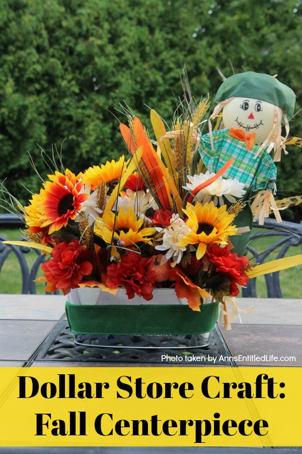 a fall centerpiece set on a picnic table in a backyard