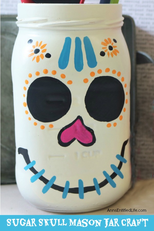 Sugar Skull Mason Jar Craft. This easy to make sugar skull is fashioned from an old Mason jar.  You can store kitchen utensils, candy (keep the lid!), etc in these jars for Halloween or to celebrate the Day of the Dead. Using old glass jars is a great way to get crafty at home and make your own cute décor at the same time.