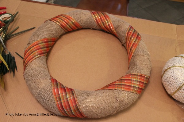 Rustic Fall Burlap Wreath DIY. This DIY tutorial on how to make a Rustic Fall Burlap Wreath has easy to follow, step-by-step instructions. Less than an hour or so of your time results in a lovely autumn wreath that is highly customizable, and a lot less expensive than a store bought wreath! Perfect fall decor for your front door. 