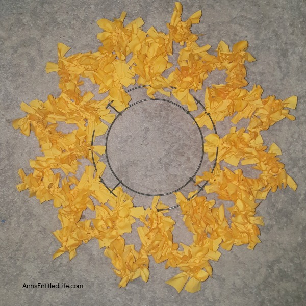 Sunflower Knot Wreath. This DIY tutorial on how to make a sunflower knot wreath has easy to follow, step-by-step instructions. An hour or so of your time results in this lovely sunflower knot wreath, perfect for your front door!