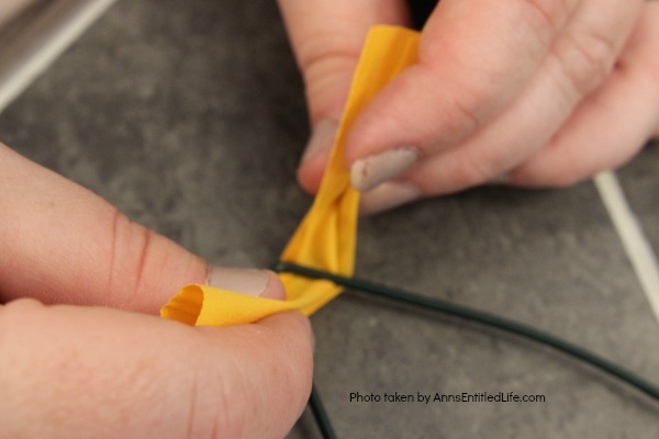 Sunflower Knot Wreath. This DIY tutorial on how to make a sunflower knot wreath has easy to follow, step-by-step instructions. An hour or so of your time results in this lovely sunflower knot wreath, perfect for your front door!