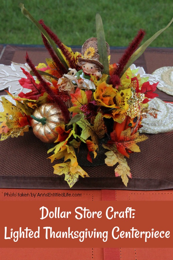 A lighted Thanksgiving centerpiece on an outdoor picnic table