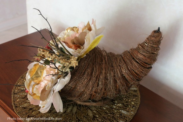 Floral Horn of Plenty DIY. This beautiful floral horn of plenty is a wonderful centerpiece or end table decorative piece, perfect for the fall season. A wonderful Thanksgiving decor accessory, this overflowing cornucopia is easy to make, and highly customizable.