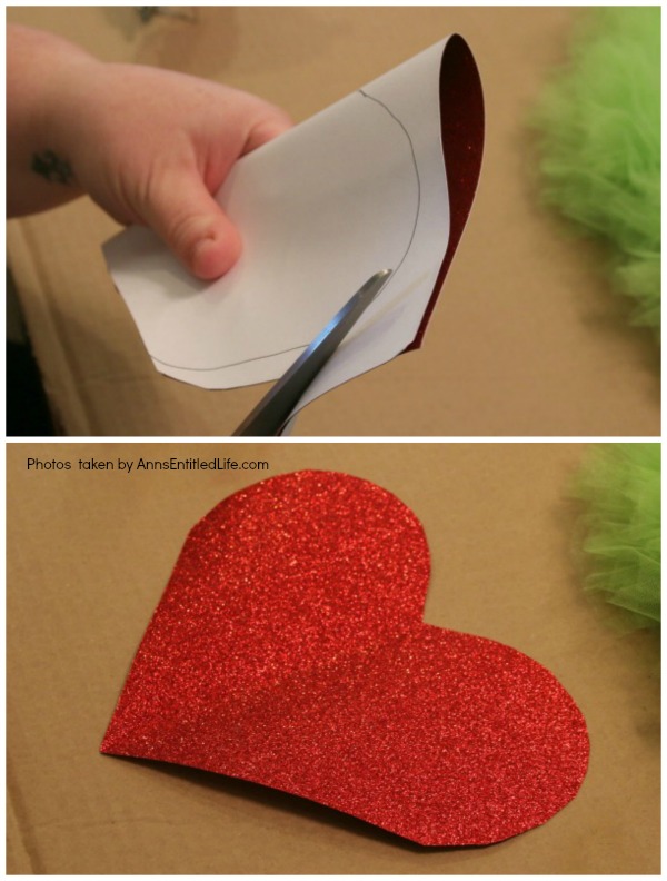 The Grinch Inspired Wreath DIY Tutorial. A beautiful Mr. Grinch inspired wreath sure to make even the coldest heart burst! This step by step tutorial is complete with (free) pdfs for the hat and heart for you to print and make exact. This wreath will look great on your front door, over your mantel, or on a wall. Truly unique holiday decor!