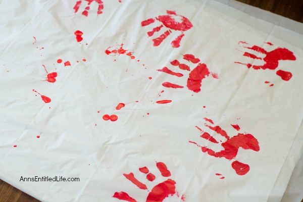 Zombie Blood Clot Tablecloth. Instead of paying big bucks for a Halloween tablecloth, make this simple Zombie tablecloth. It adds a touch of spookiness to your Halloween party table. Five minutes, plus dry time, and your Halloween table has a spooktacular covering!