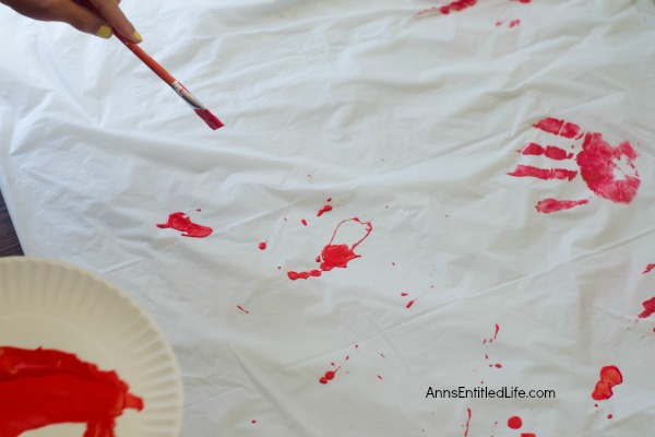 Zombie Blood Clot Tablecloth. Instead of paying big bucks for a Halloween tablecloth, make this simple Zombie tablecloth. It adds a touch of spooky to your Halloween party table. Five minutes, plus dry time, and your Halloween table has a spooktacular covering!